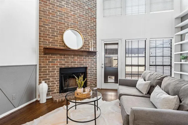 a living room with furniture a fireplace and window