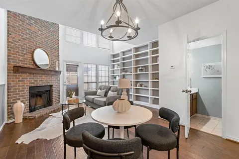 a view of a dining room with furniture a chandelier and wooden floor
