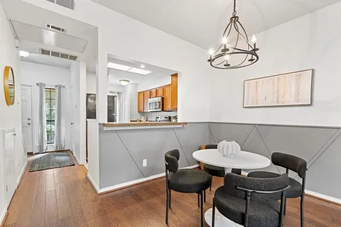 a view of a dining room with furniture and chandelier