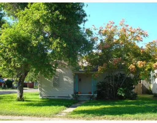 a garden with trees in front of it