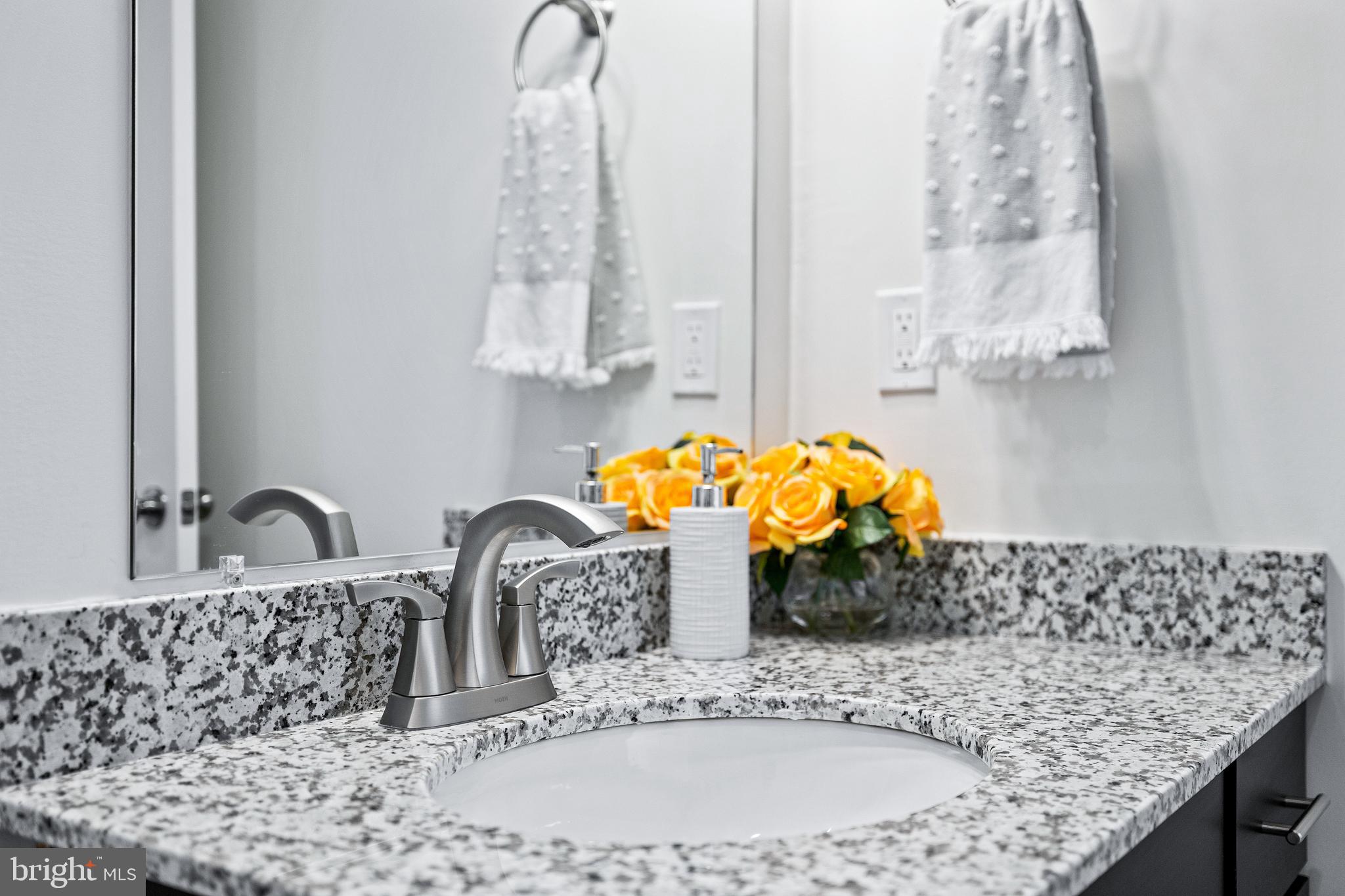 1006 Admiral Lane, Unit 304 Hanover, PA 17331 - Photo 26 of 36 a bathroom with a granite countertop sink and a mirror