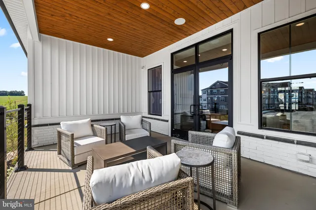 a outdoor space with patio couch and a potted plant