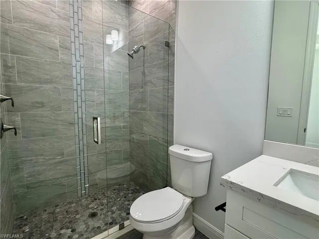 a bathroom with a toilet a sink and shower