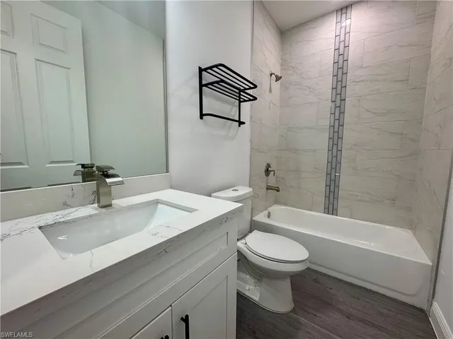 a bathroom with a sink a toilet and a bathtub