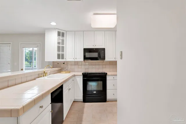 a kitchen with a sink stove and microwave