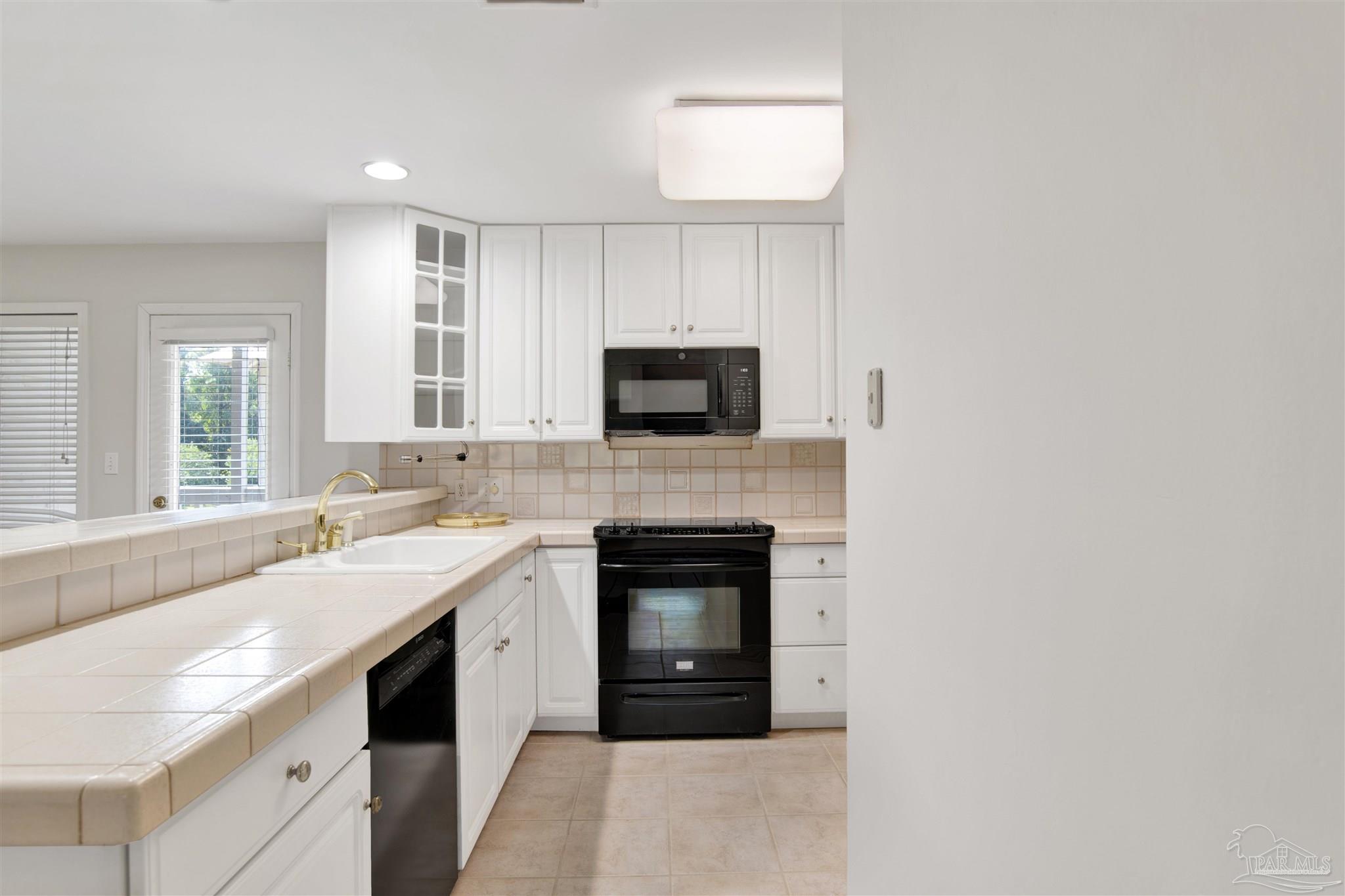 13414 Valerie Drive Pensacola, FL 32507 - Photo 14 of 35 a kitchen with a sink stove and microwave