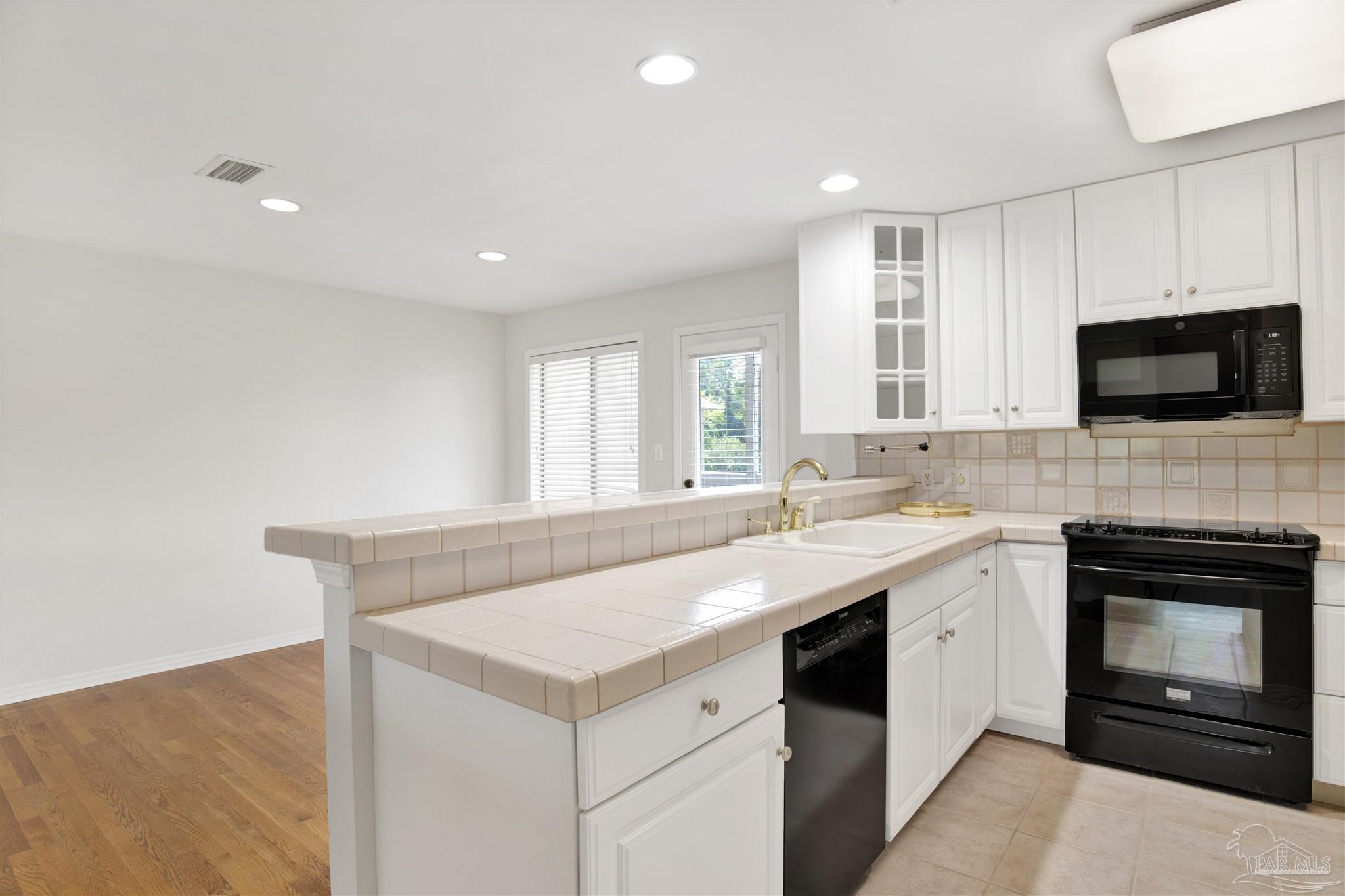 13414 Valerie Drive Pensacola, FL 32507 - Photo 15 of 35 a kitchen with a stove and a sink