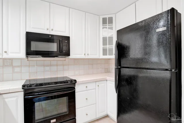 a kitchen with a refrigerator stove and microwave