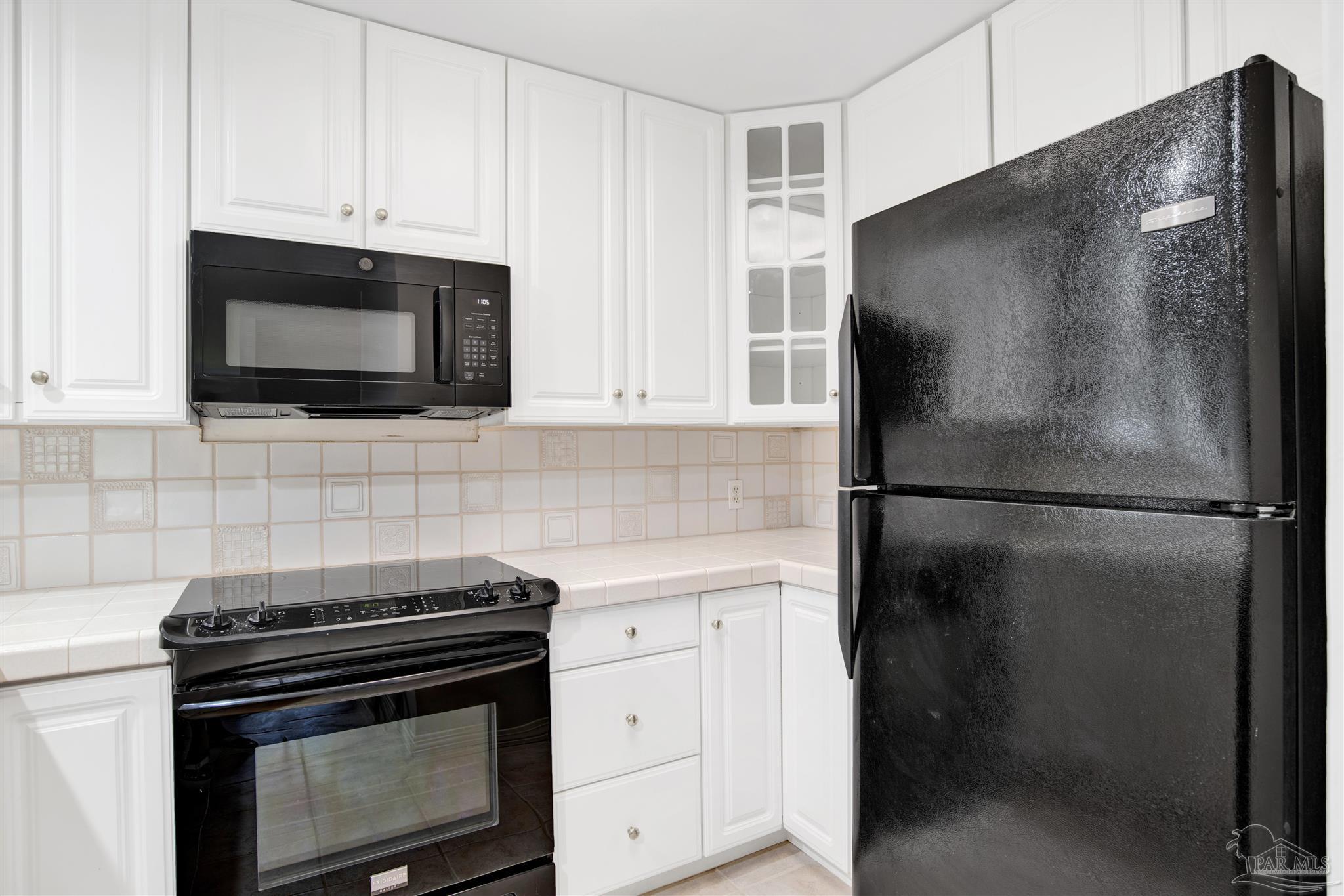 13414 Valerie Drive Pensacola, FL 32507 - Photo 16 of 35 a kitchen with a refrigerator stove and microwave