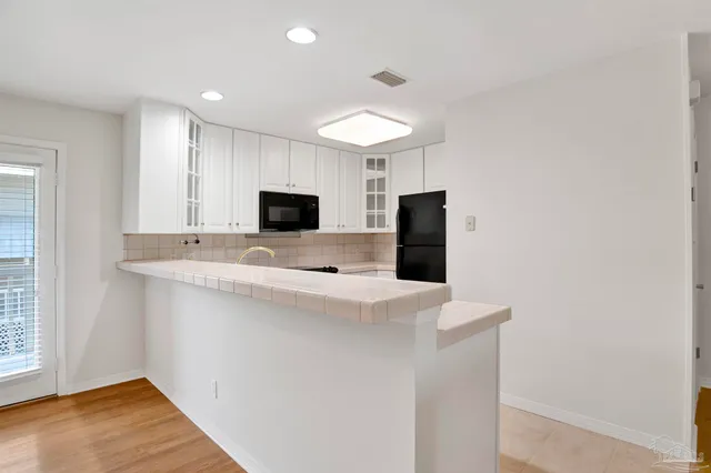 a view of kitchen with microwave and stove