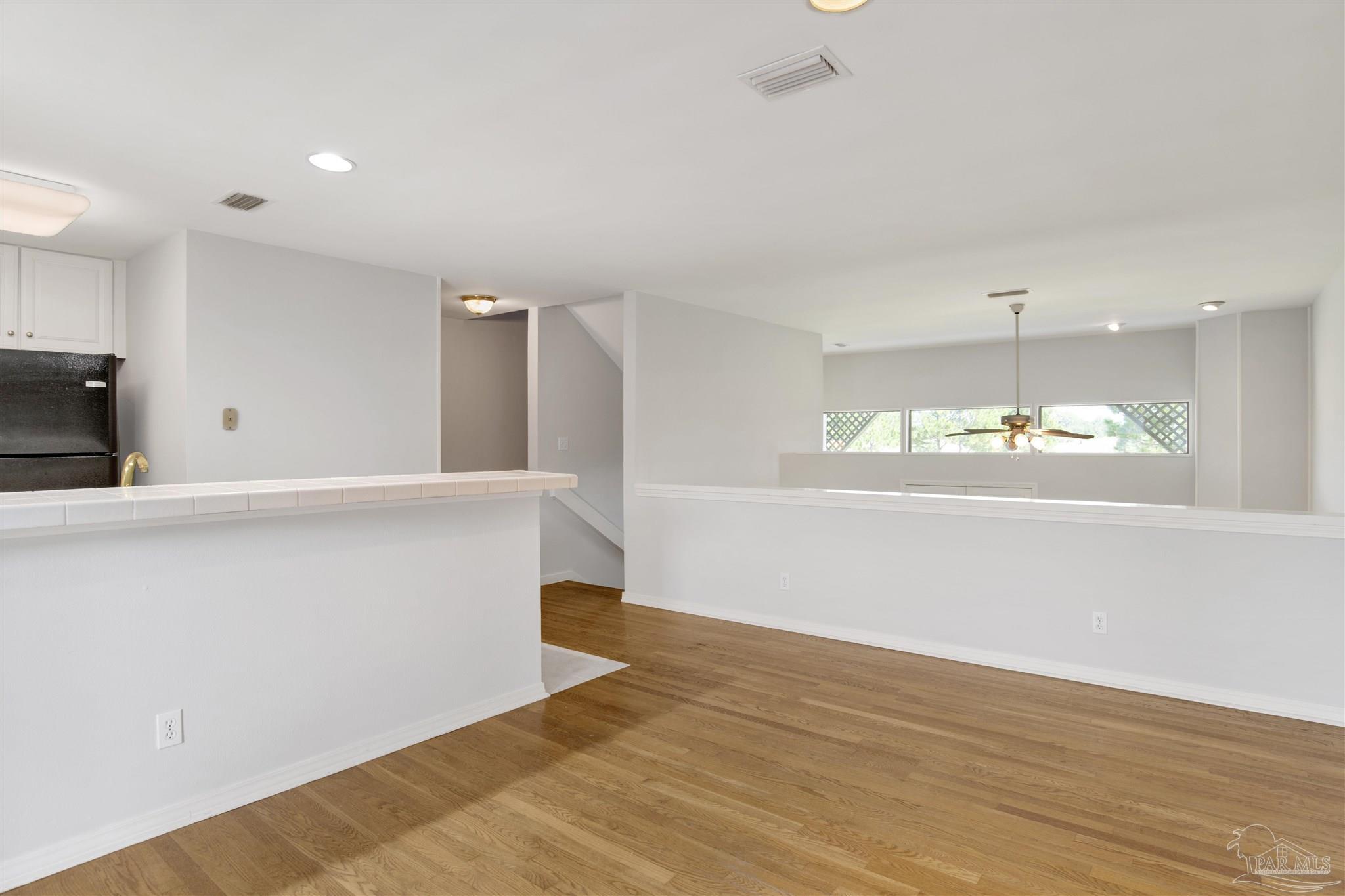 13414 Valerie Drive Pensacola, FL 32507 - Photo 21 of 35 a view of an empty room with window and wooden floor