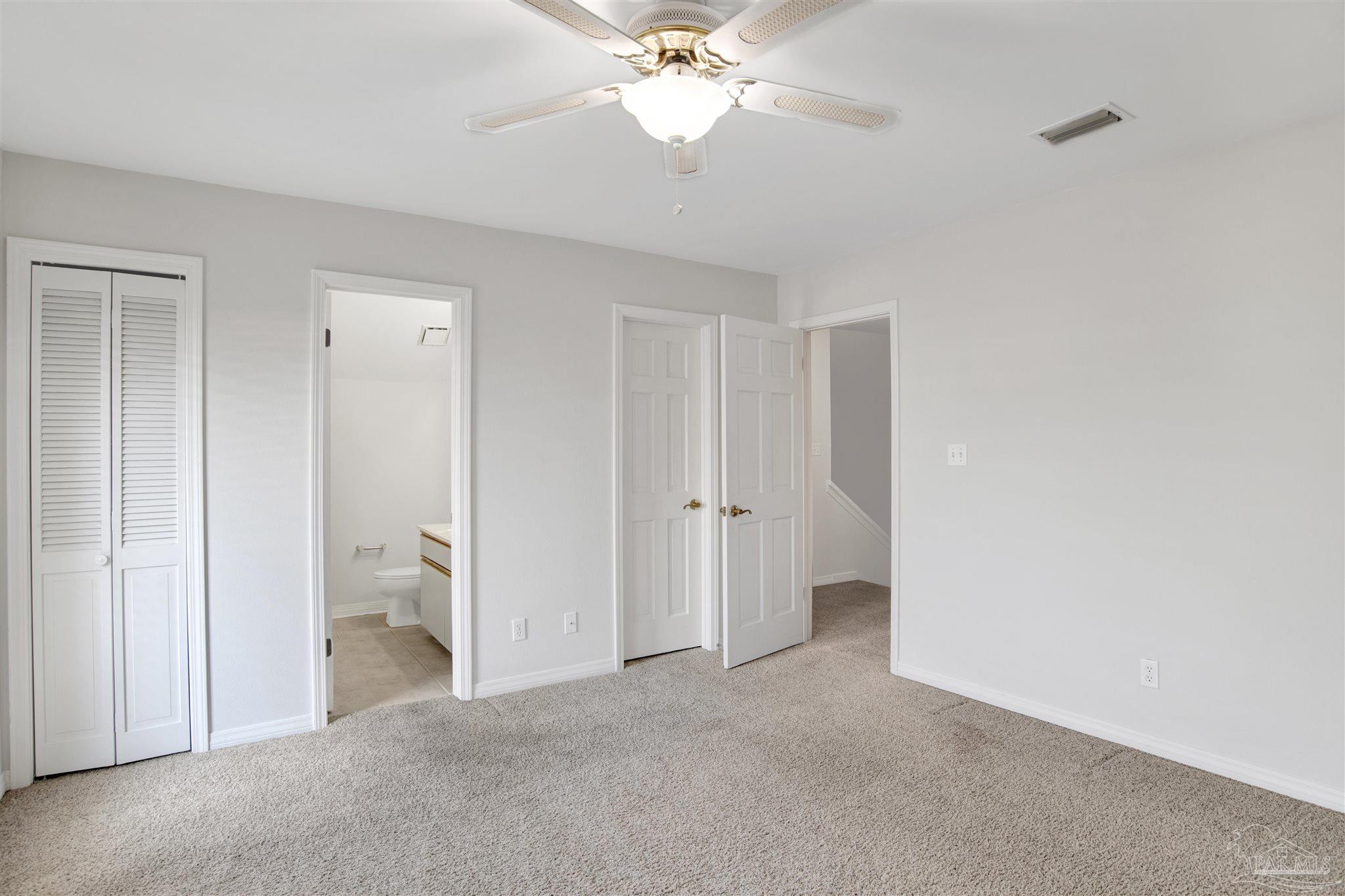 13414 Valerie Drive Pensacola, FL 32507 - Photo 25 of 35 a view of a room with a ceiling fan and a bathroom