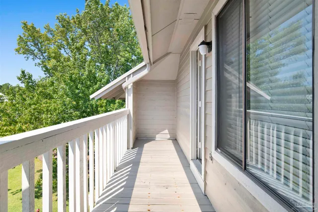 a view of a balcony with wooden floor