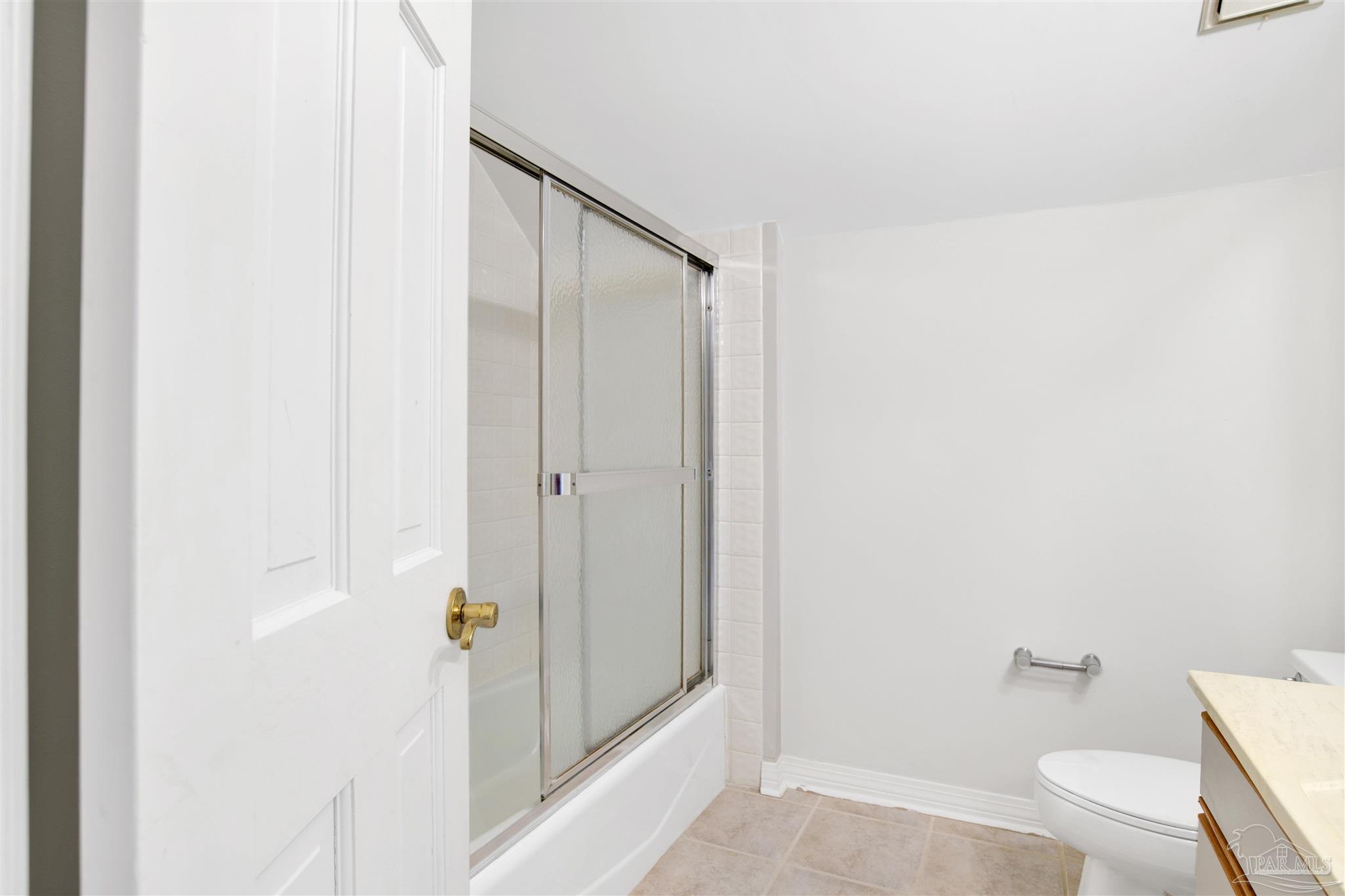 13414 Valerie Drive Pensacola, FL 32507 - Photo 28 of 35 a bathroom with a granite countertop shower and a toilet