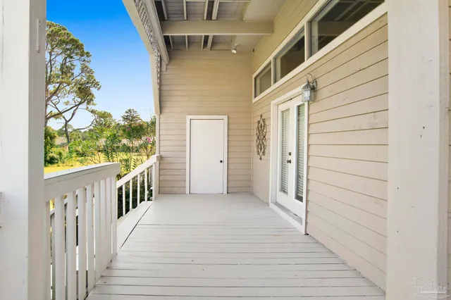 a view of a porch with wooden floor and stairs