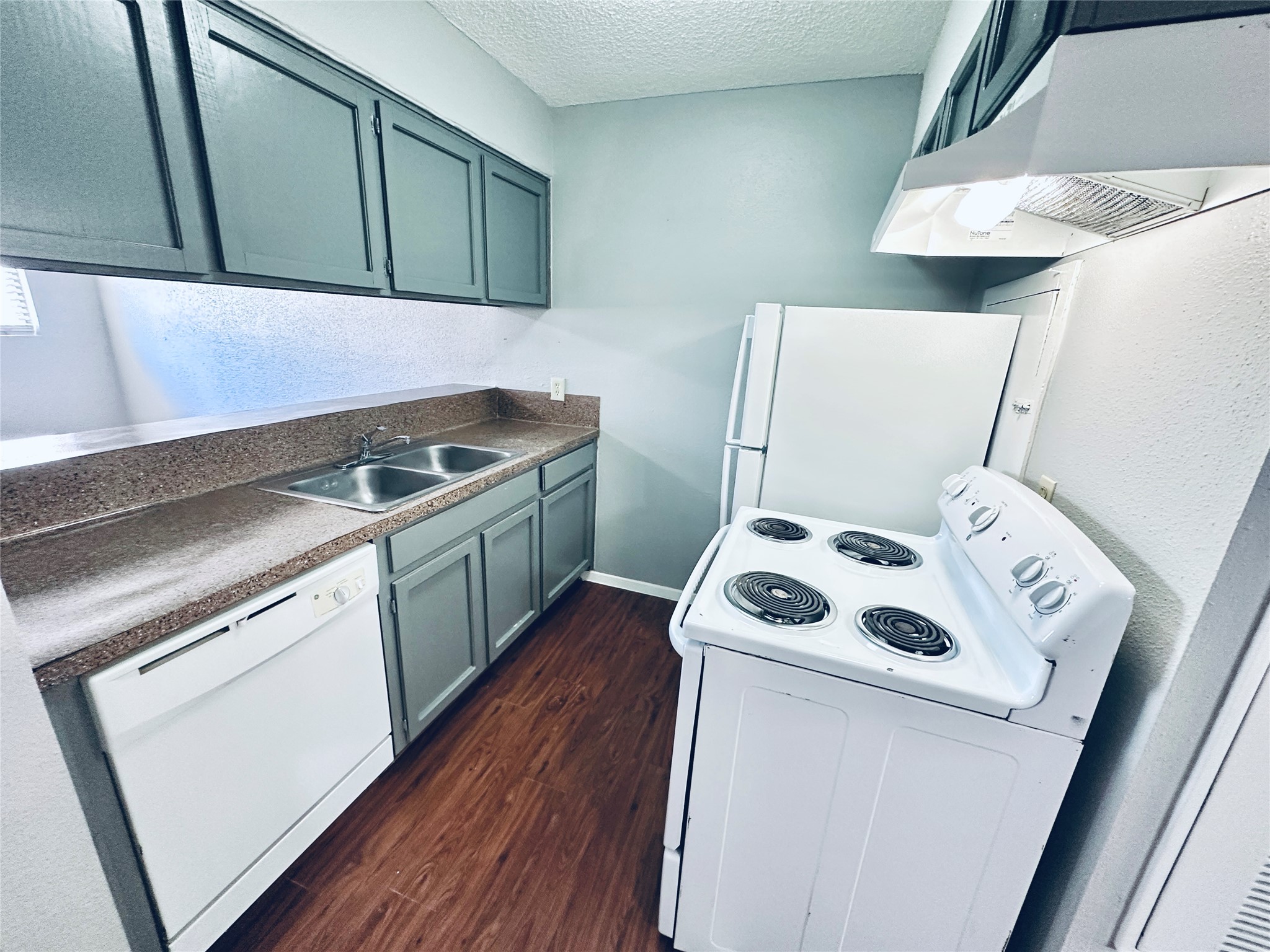 3702 South 2nd Street, Unit 107 Austin, TX 78704 - Photo 1 of 12 a kitchen with a stove and a microwave