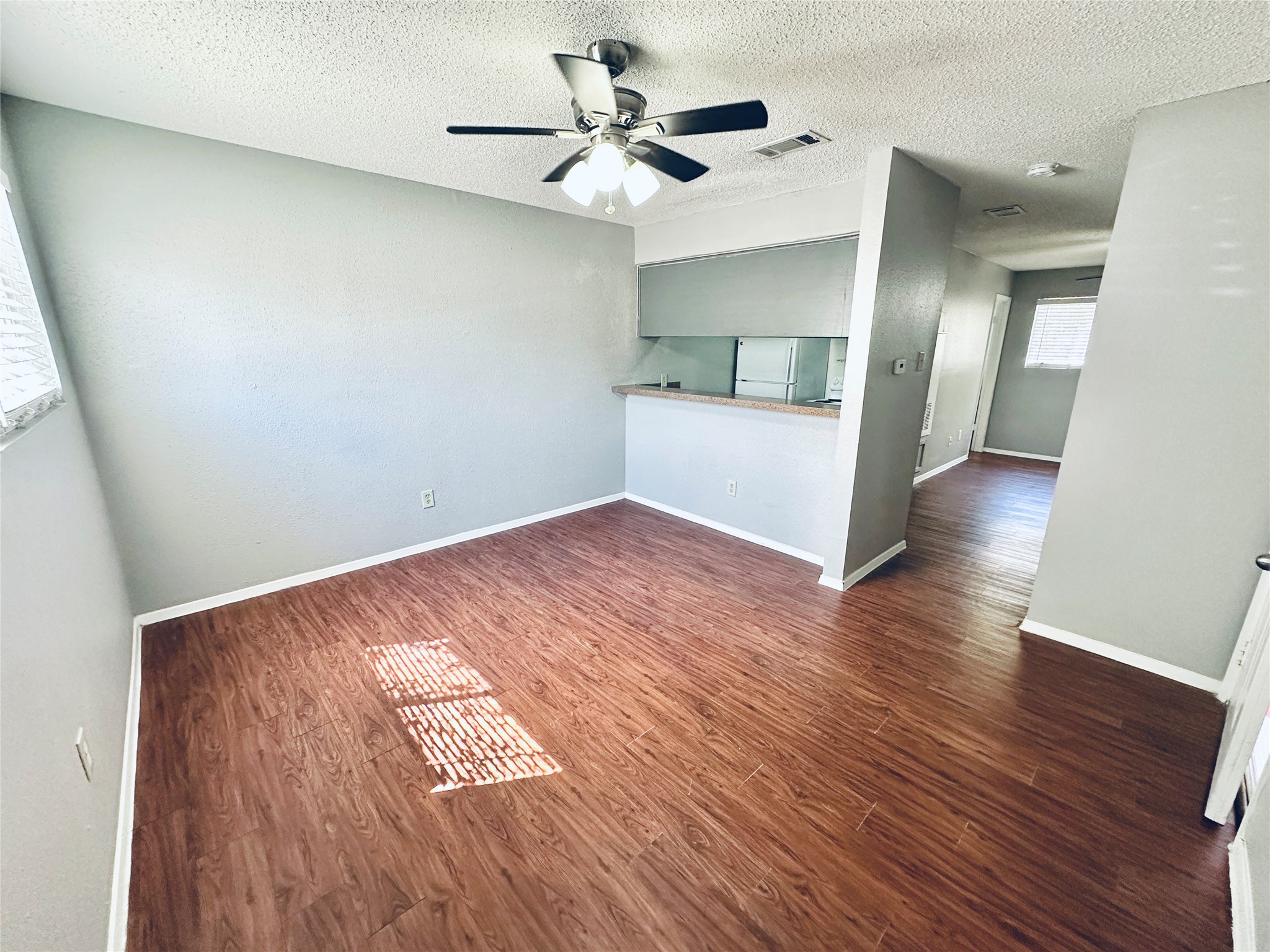 3702 South 2nd Street, Unit 107 Austin, TX 78704 - Photo 5 of 12 an empty room with wooden floor and a ceiling fan