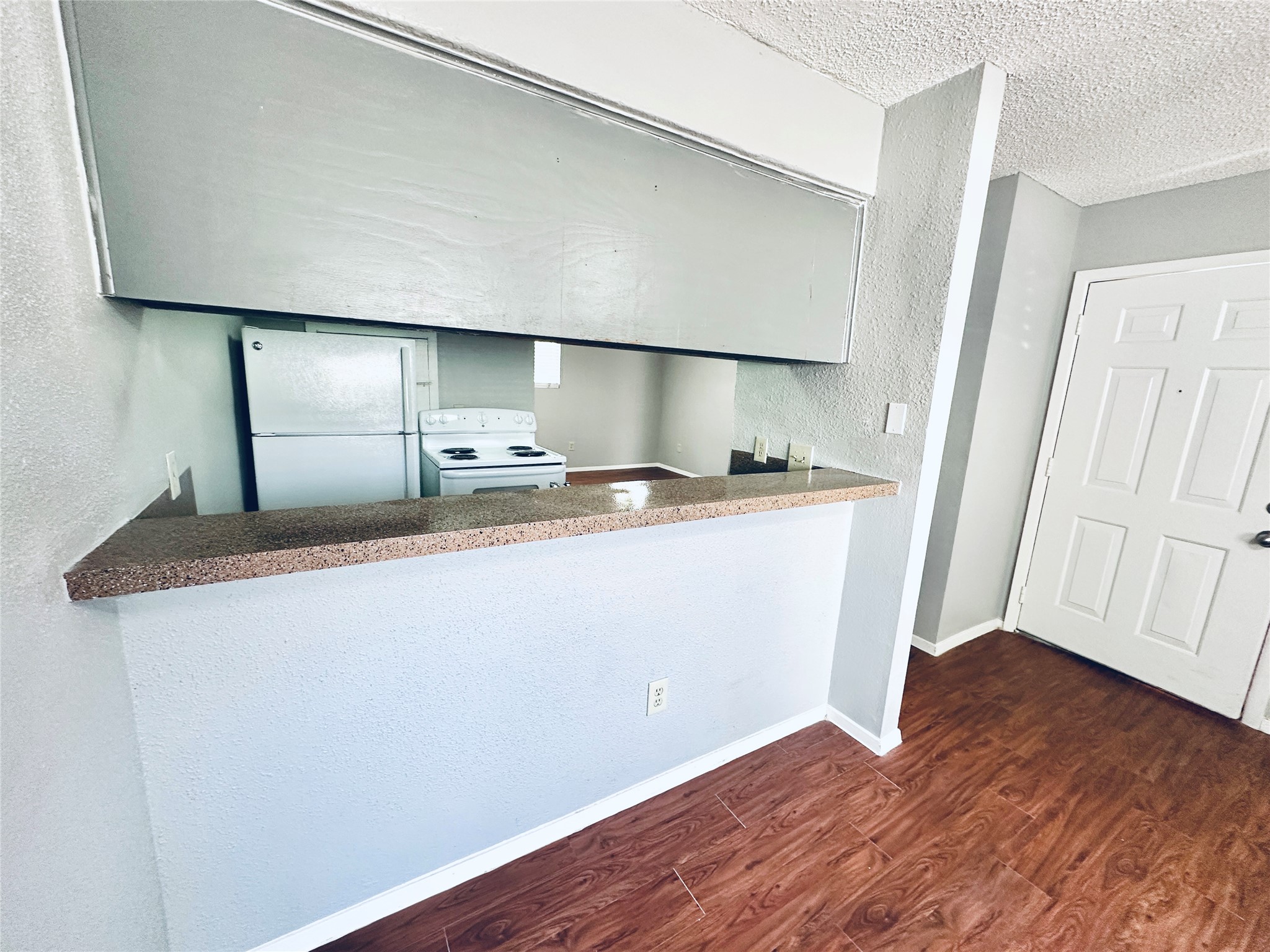 3702 South 2nd Street, Unit 107 Austin, TX 78704 - Photo 7 of 12 a kitchen with a sink a refrigerator and wooden floor