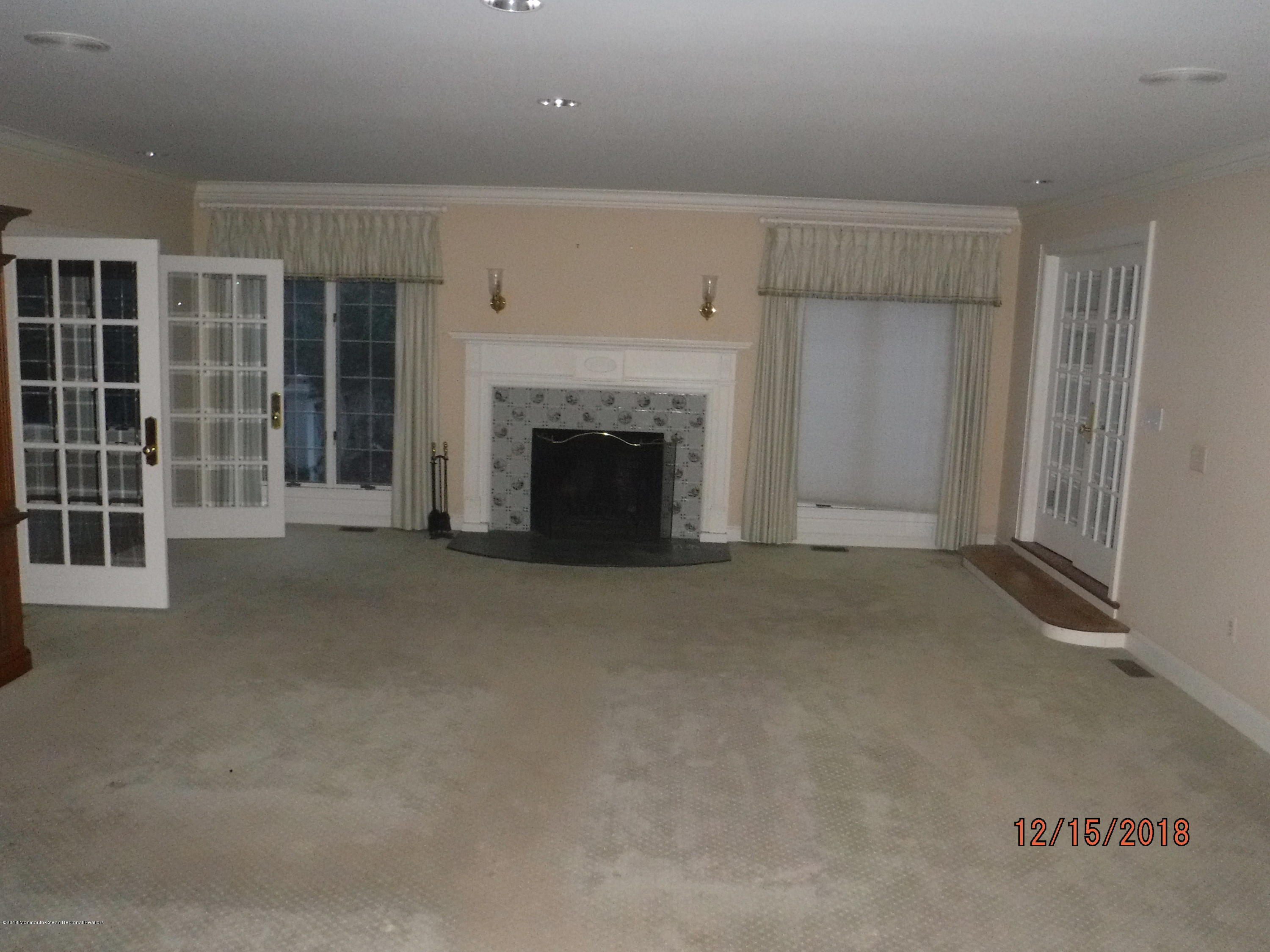 23 Paddock Lane Colts Neck, NJ 07722 - Photo 20 of 64 Living room with fireplace