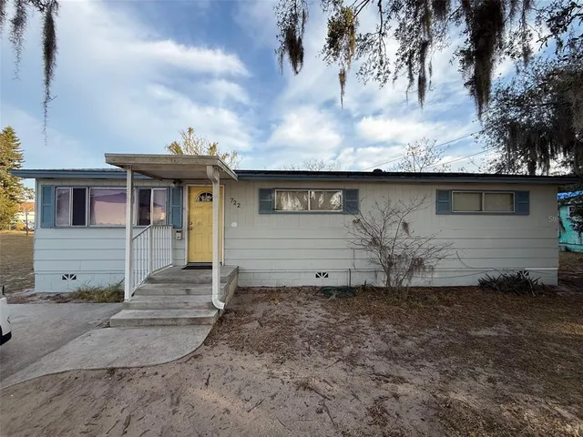 a view of a house with a yard and garage