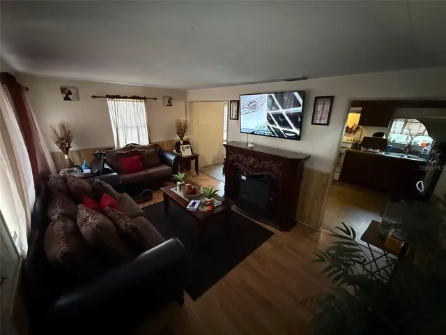 a living room with furniture a rug and a window