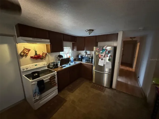 a kitchen with a stove and a refrigerator
