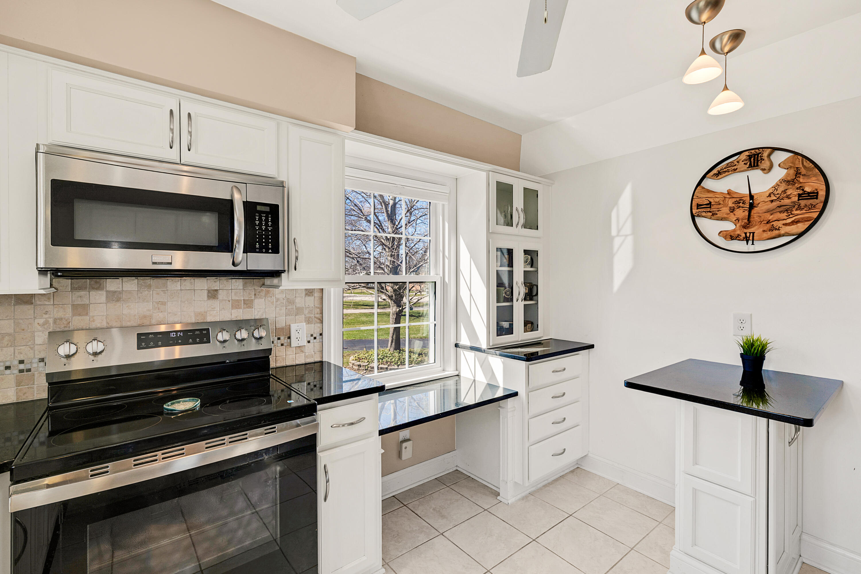 8550 North Regent Road Fox Point, WI 53217 - Photo 9 of 24 A small island for two people to eat in the kitchen.