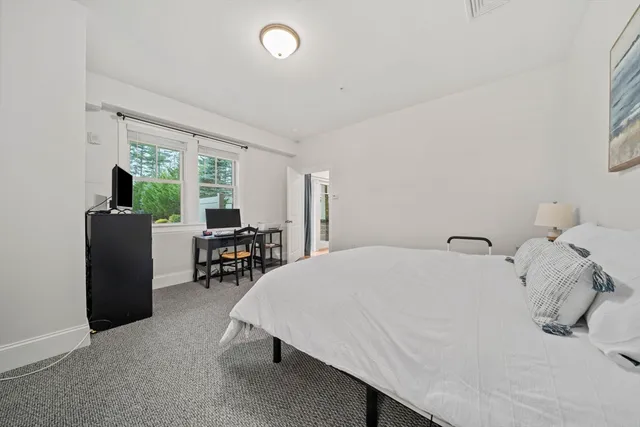 a bathroom with a toilet sink vanity granite and mirror