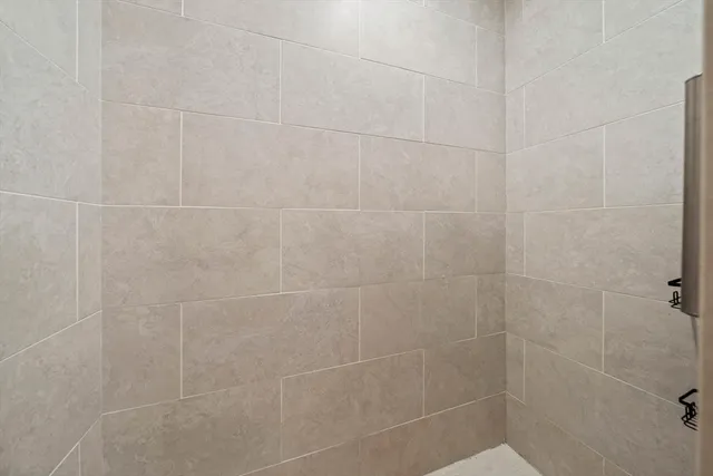 a view of walk in closet with clothes