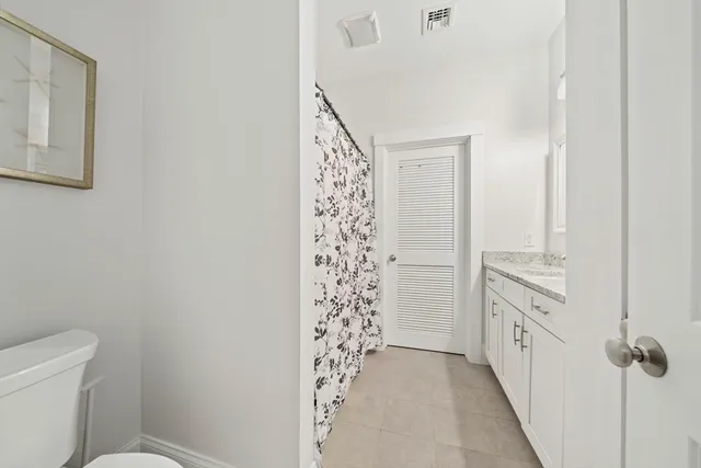 a bathroom with a granite countertop sink a mirror a vanity and a shower