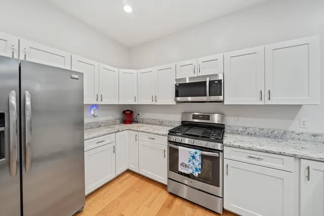 a view of a dining hall with furniture and wooden floor