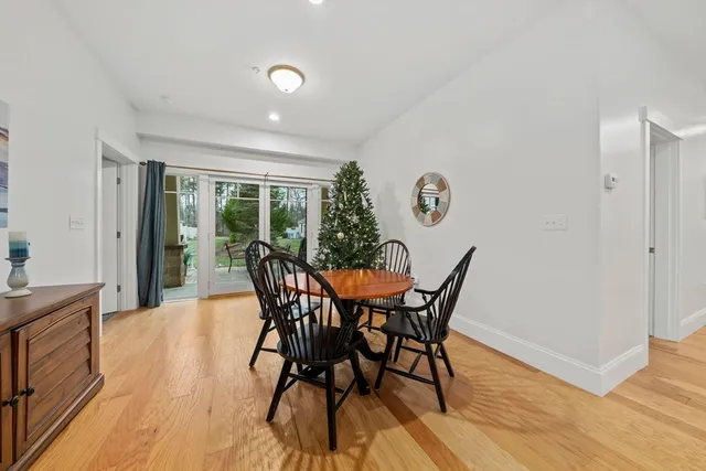 a dining room with furniture and wooden floor