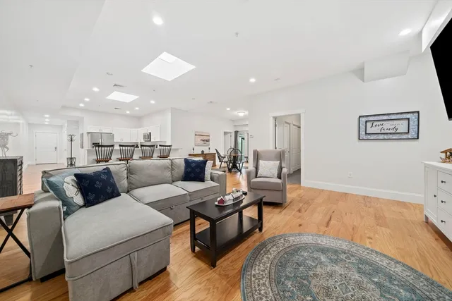 a view of a hallway with wooden floor and a workspace