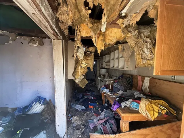 a view of a dry yard with wooden fence