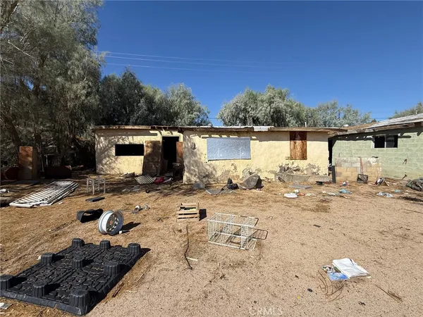 a view of a house with wooden fence
