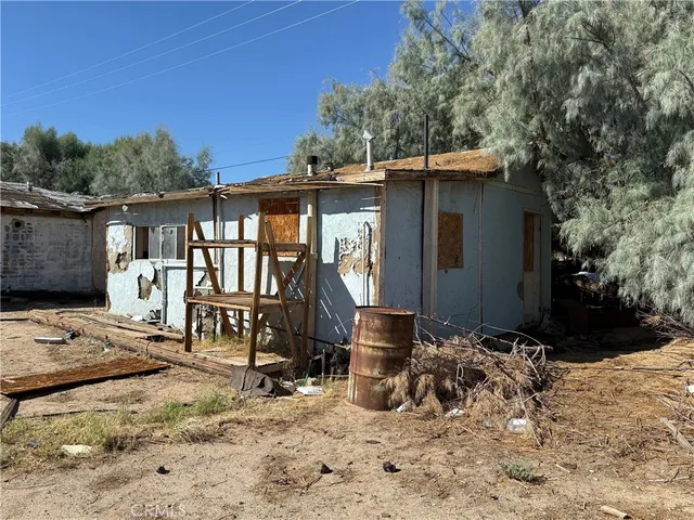 a view of a wooden house with chairs in patio