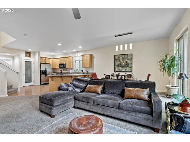 a living room with furniture and kitchen view