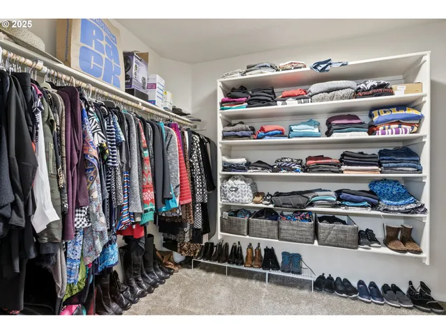 a bedroom with a bed a chandelier and a window
