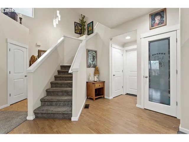 a view of entryway and hall with wooden floor
