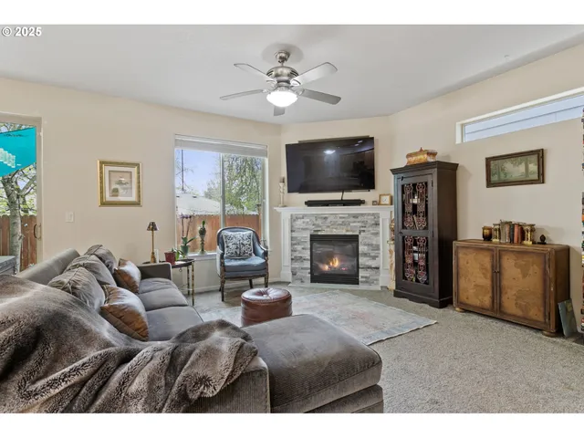 a living room with furniture a fireplace and a flat screen tv