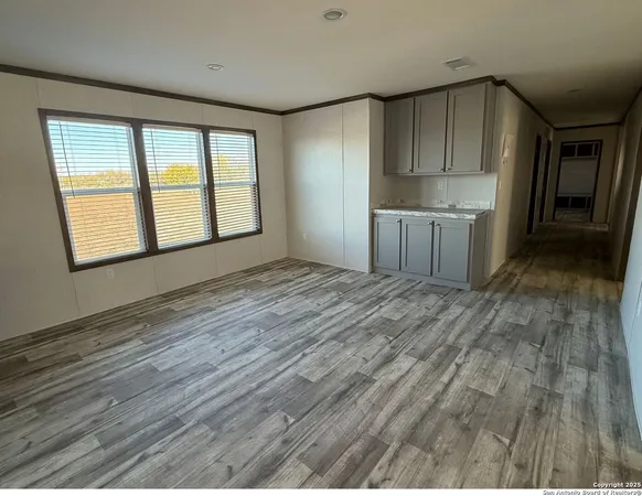 a view of a kitchen with wooden floor and a kitchen