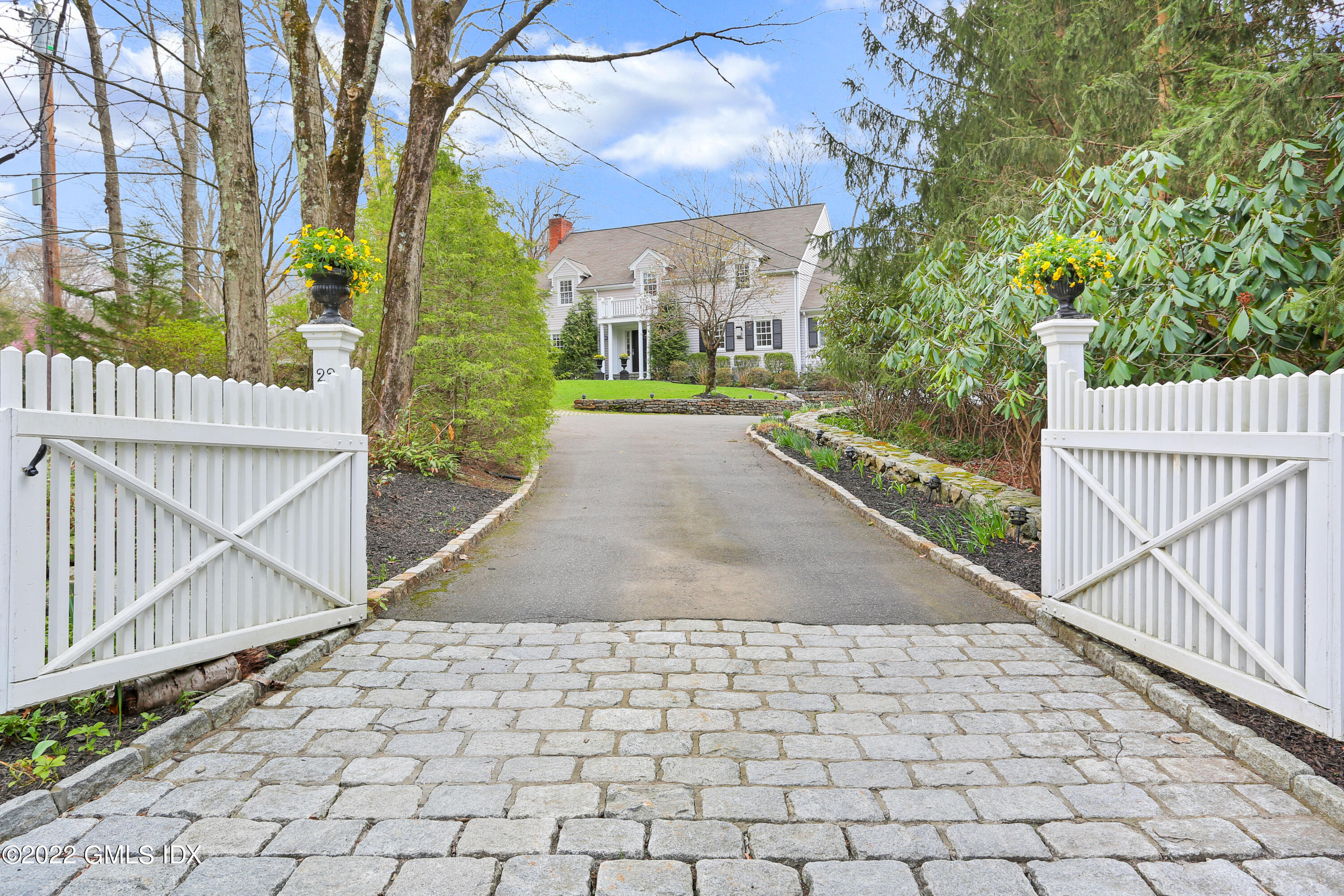 22 Indian Mill Road Cos Cob, CT 06807 - Photo 1 of 24 a view of a pathway with a white house with wooden floor and fence next to a yard