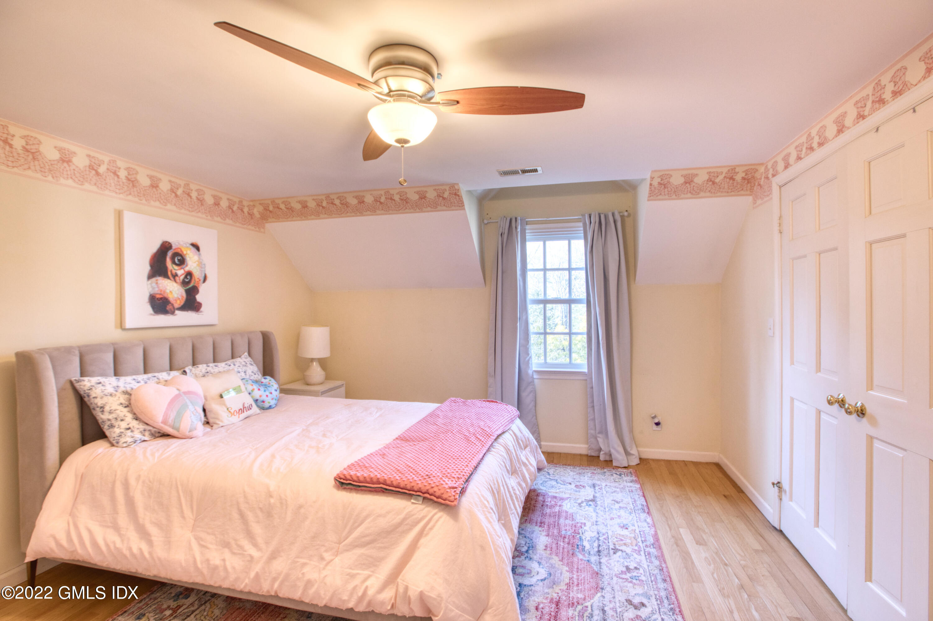 22 Indian Mill Road Cos Cob, CT 06807 - Photo 16 of 24 a bedroom with a large bed and a chandelier