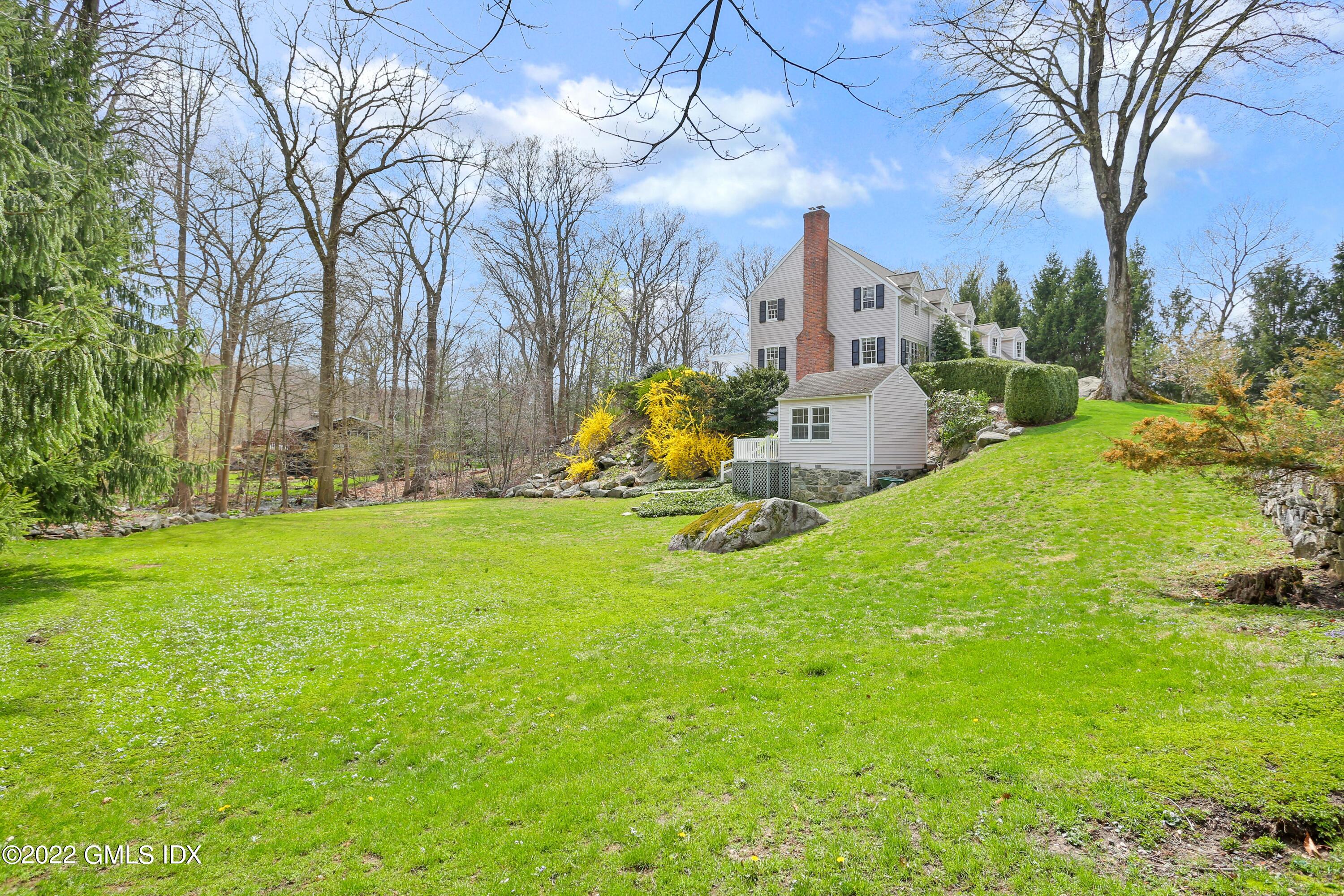 22 Indian Mill Road Cos Cob, CT 06807 - Photo 24 of 24 a view of a house with garden and a bench