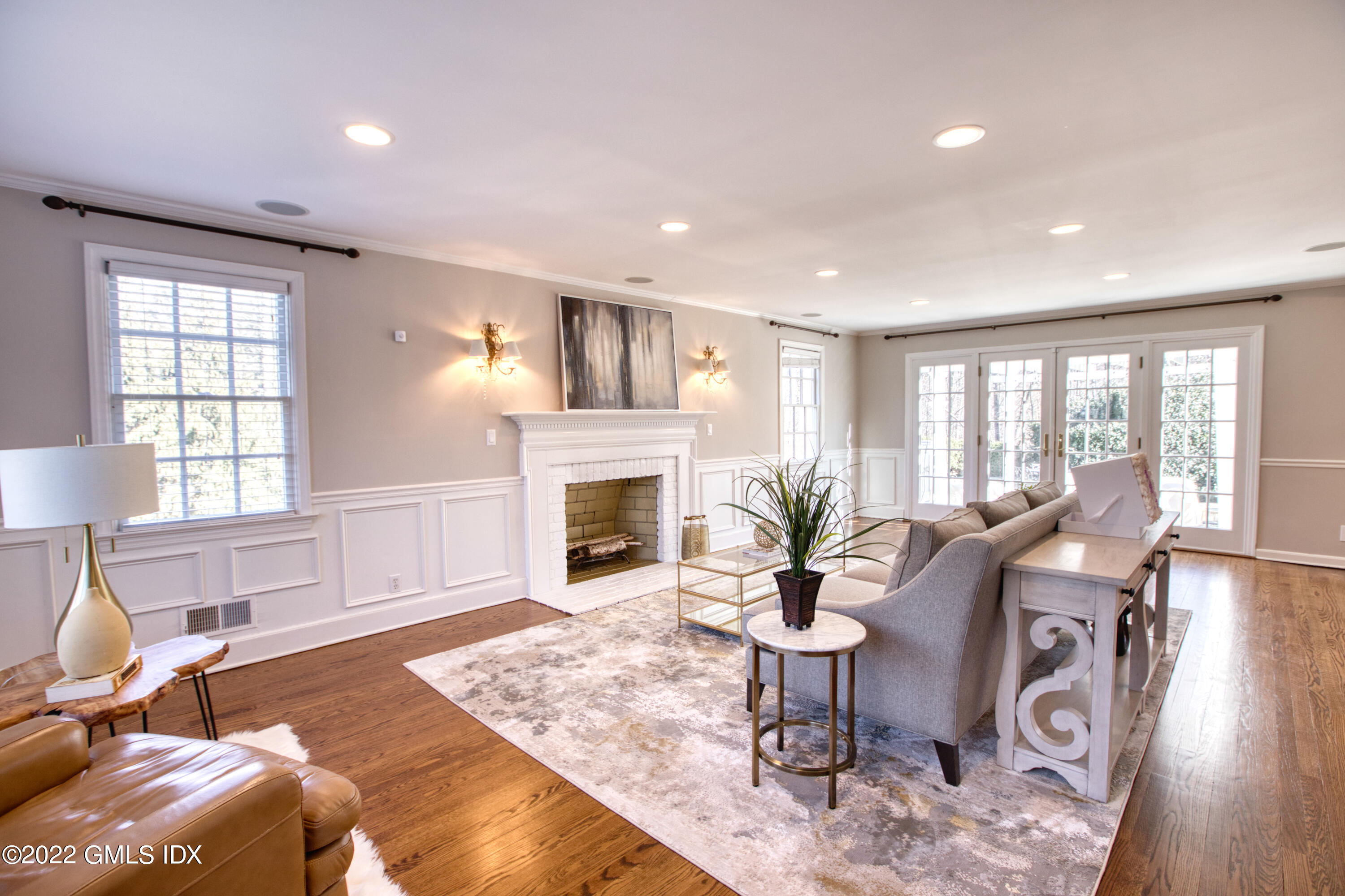 22 Indian Mill Road Cos Cob, CT 06807 - Photo 4 of 24 a living room with furniture a fireplace and a table with wooden floor