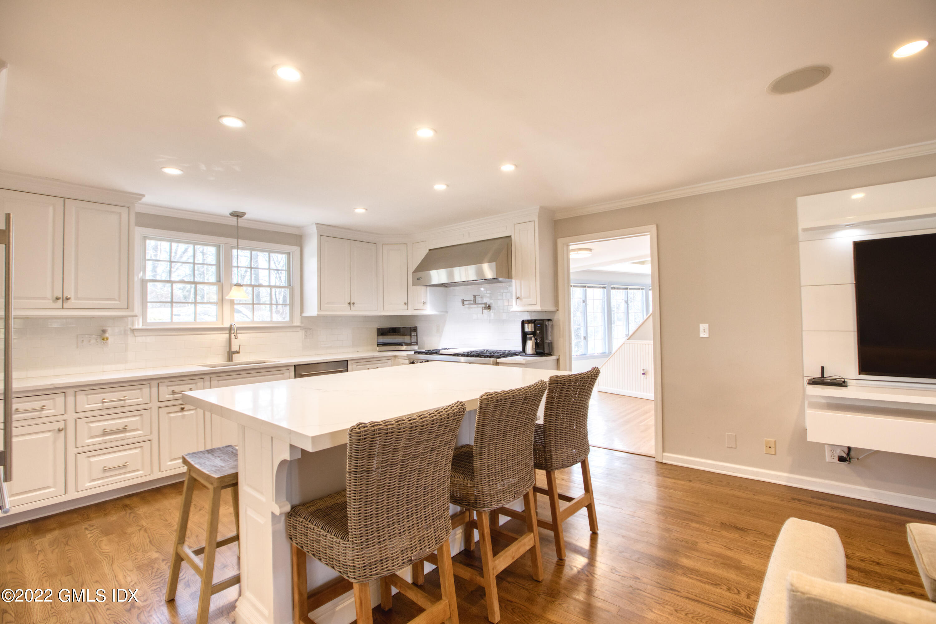 22 Indian Mill Road Cos Cob, CT 06807 - Photo 8 of 24 a large kitchen with a table and chairs