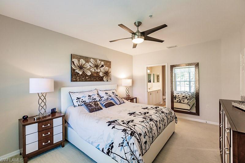 8135 Celeste Drive, Unit 4218 Naples, FL 34113 - Photo 11 of 37 a bedroom with a large bed and a window