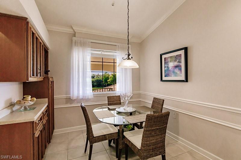 8135 Celeste Drive, Unit 4218 Naples, FL 34113 - Photo 13 of 37 a dining room with furniture and window