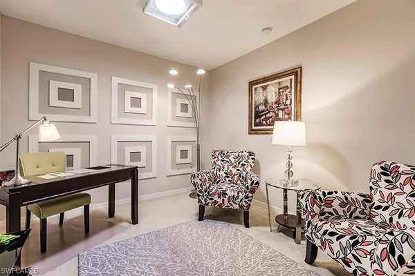 a bedroom with furniture and a flat screen tv