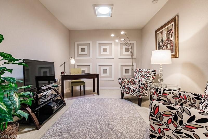 8135 Celeste Drive, Unit 4218 Naples, FL 34113 - Photo 18 of 37 a bedroom with furniture and a flat screen tv